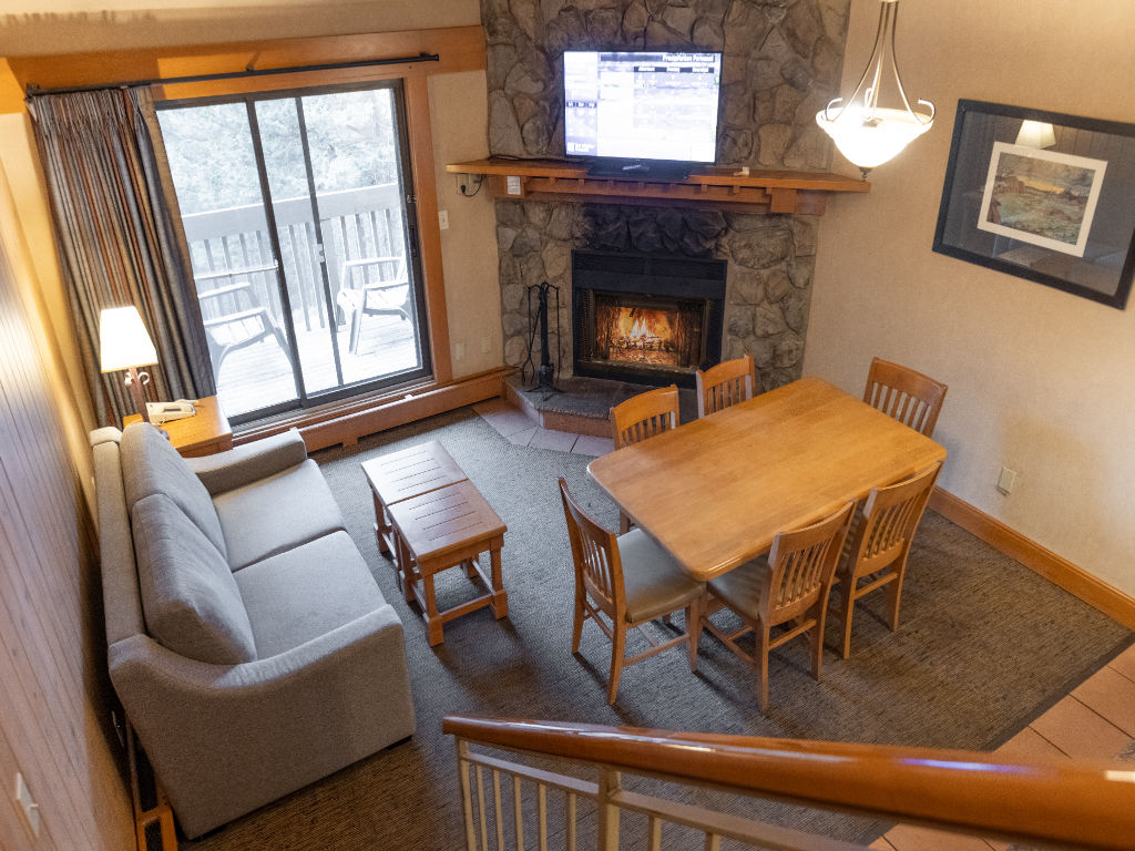 image Enjoy the comfort of this inviting living and dining area, featuring a rustic charm and cozy furnishings ideal for shared moments.