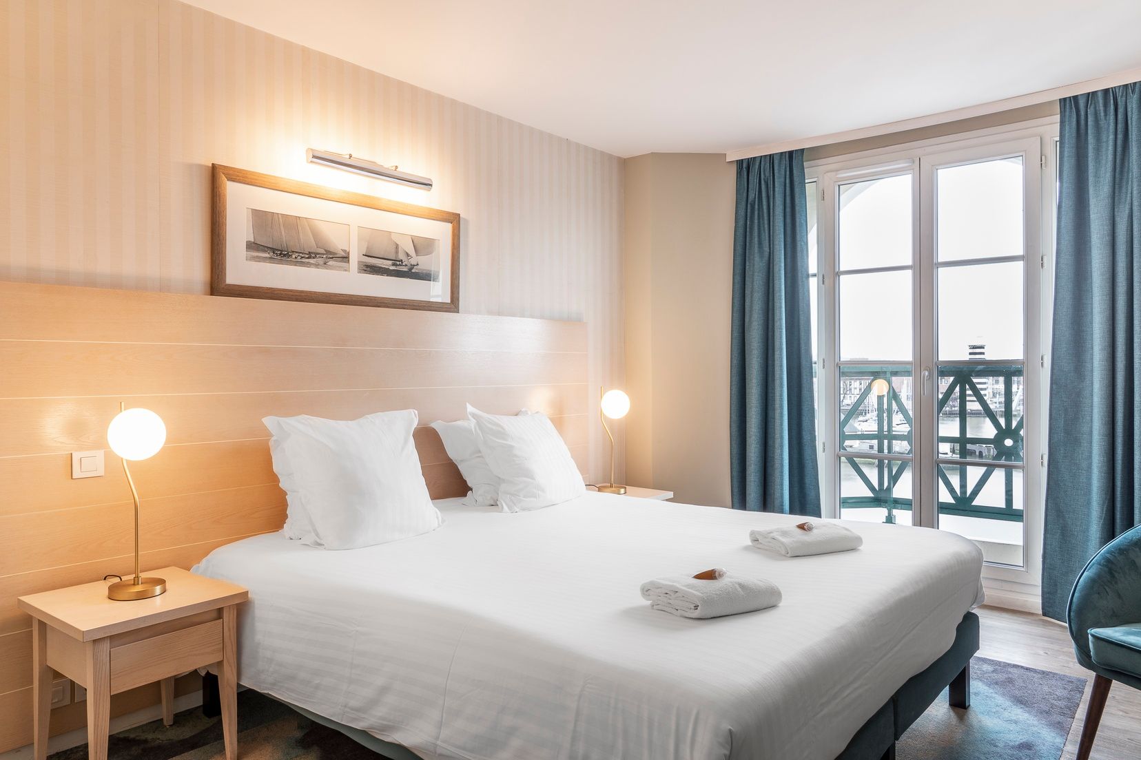 image Double bed with a window view of the marina and boats