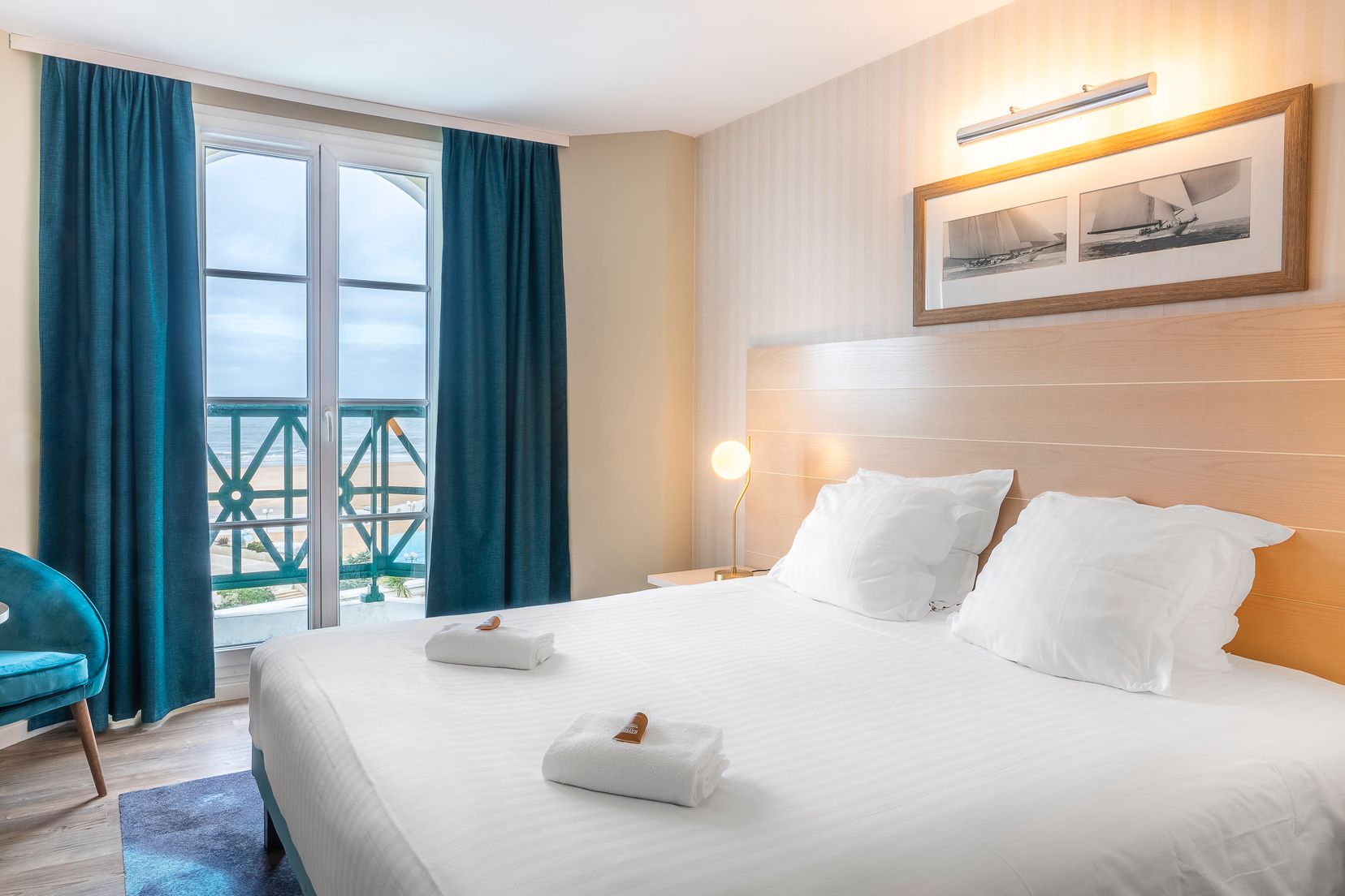 image Double bed with a window view of the beach and sea