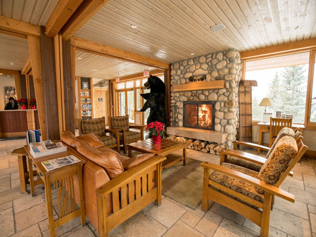 image Gather in the resort lounge, featuring a crackling fireplace and rustic decor for a welcoming retreat.