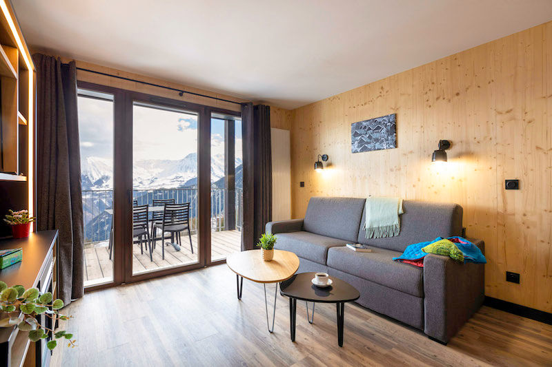 image Snuggle up with a cup of coffee or tea on the comfortable sofa. Views vary.