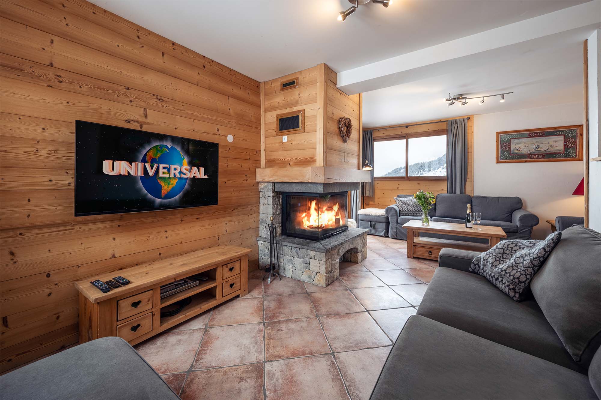 image Well-appointed living room with TV, fireplace, and comfortable seating