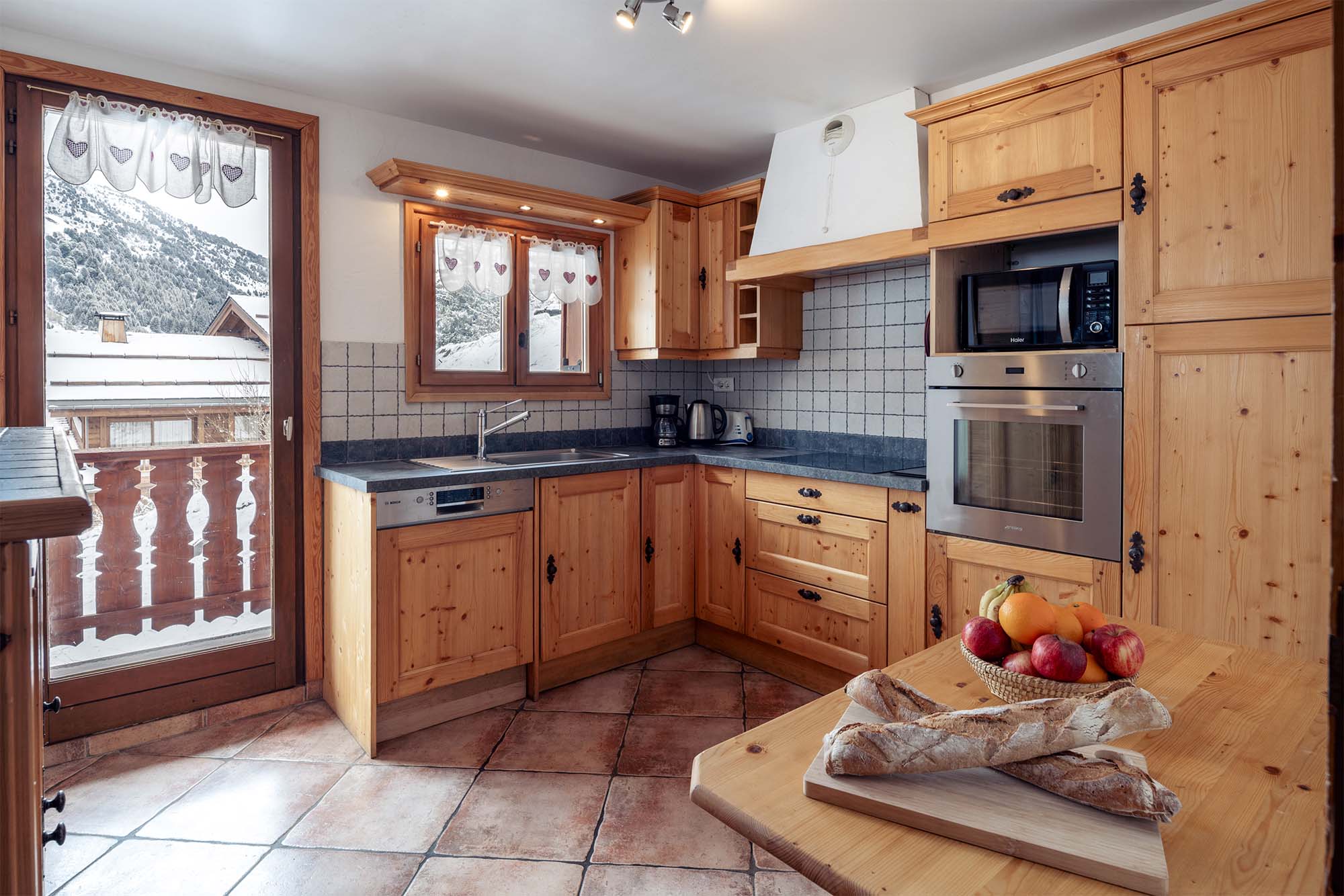 image Fully-equipped kitchen with beautiful wooden cabinetry and ample table space