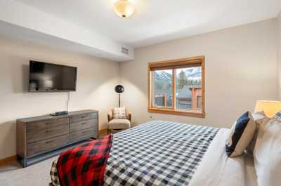 The master bedroom features a comfy plush king bed and a smart TV. 