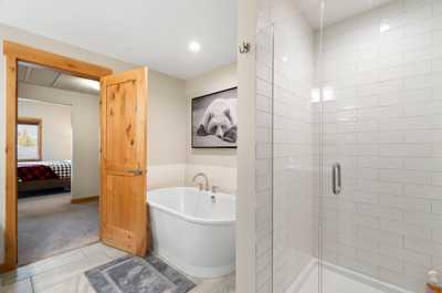 The ensuite bathroom features both a bathtub and a shower.