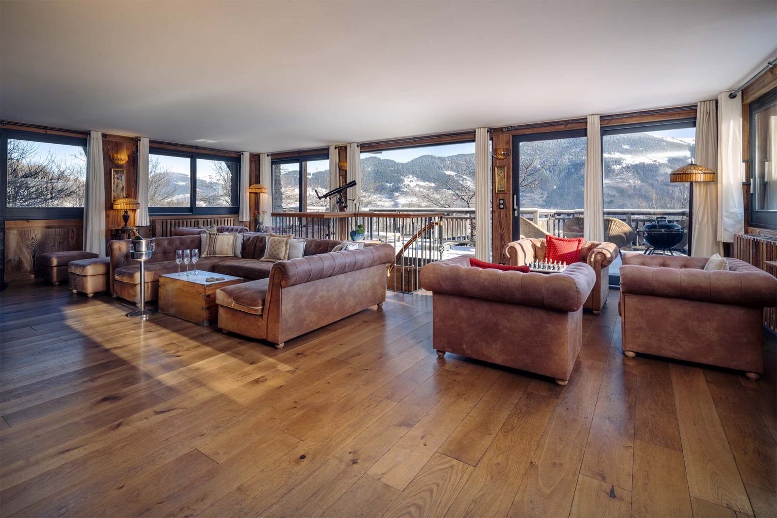 image Relax on the plush sofas with a game of chess and mountain views beyond