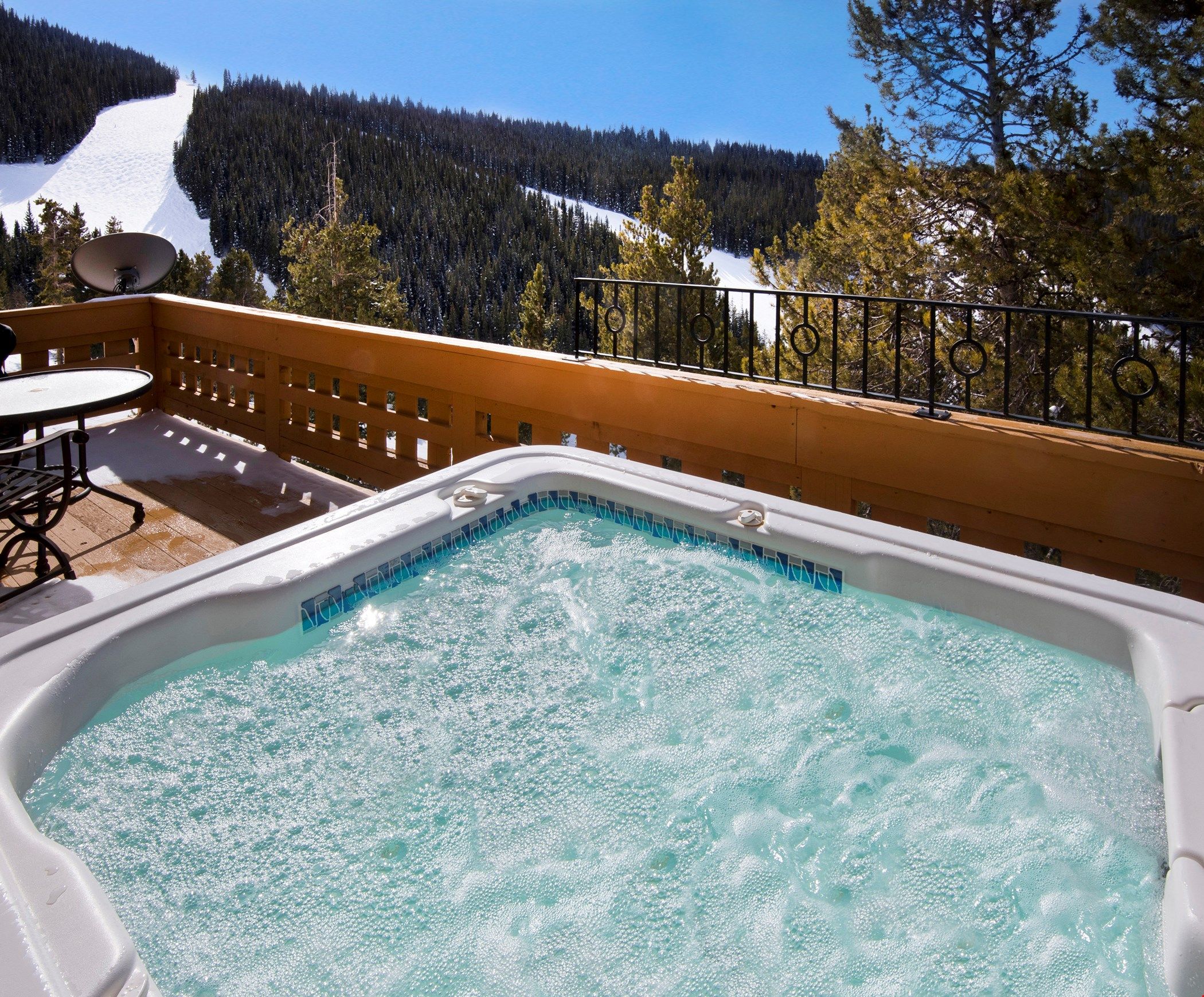 image Soak sore muscles in the private outdoor hot tub after a day on the mountain.