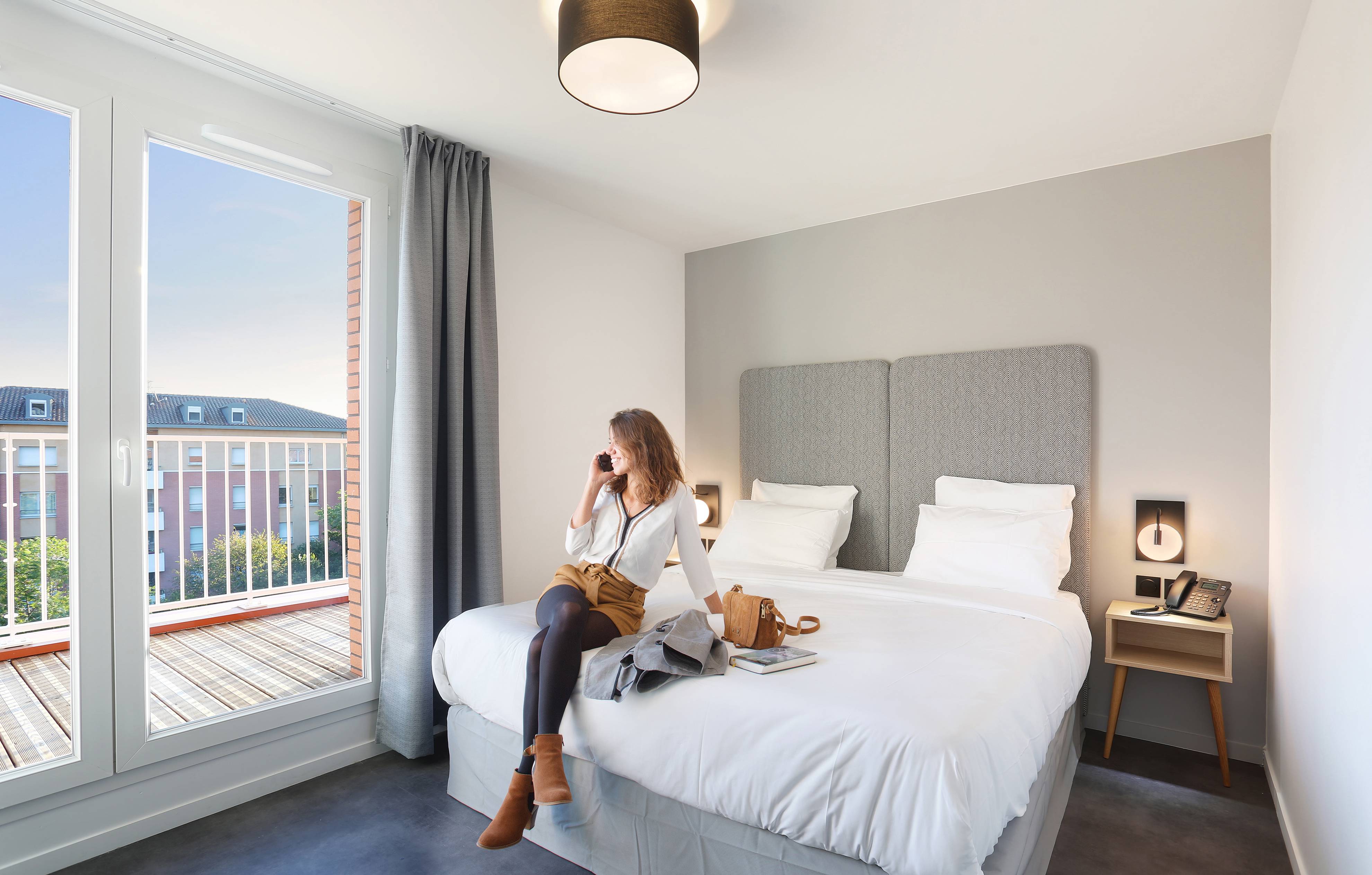 image Relax on the comfy bed after a day outside. Please note that we cannot guarantee that your unit will come with a balcony.