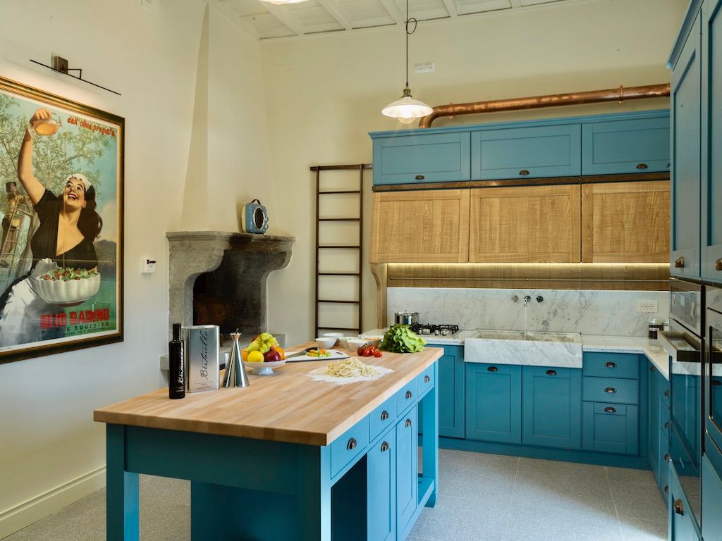 image The spacious kitchen includes a wood-burning fireplace, a butcher block centre island, and J. A. Henckels chef’s knives and silverware.