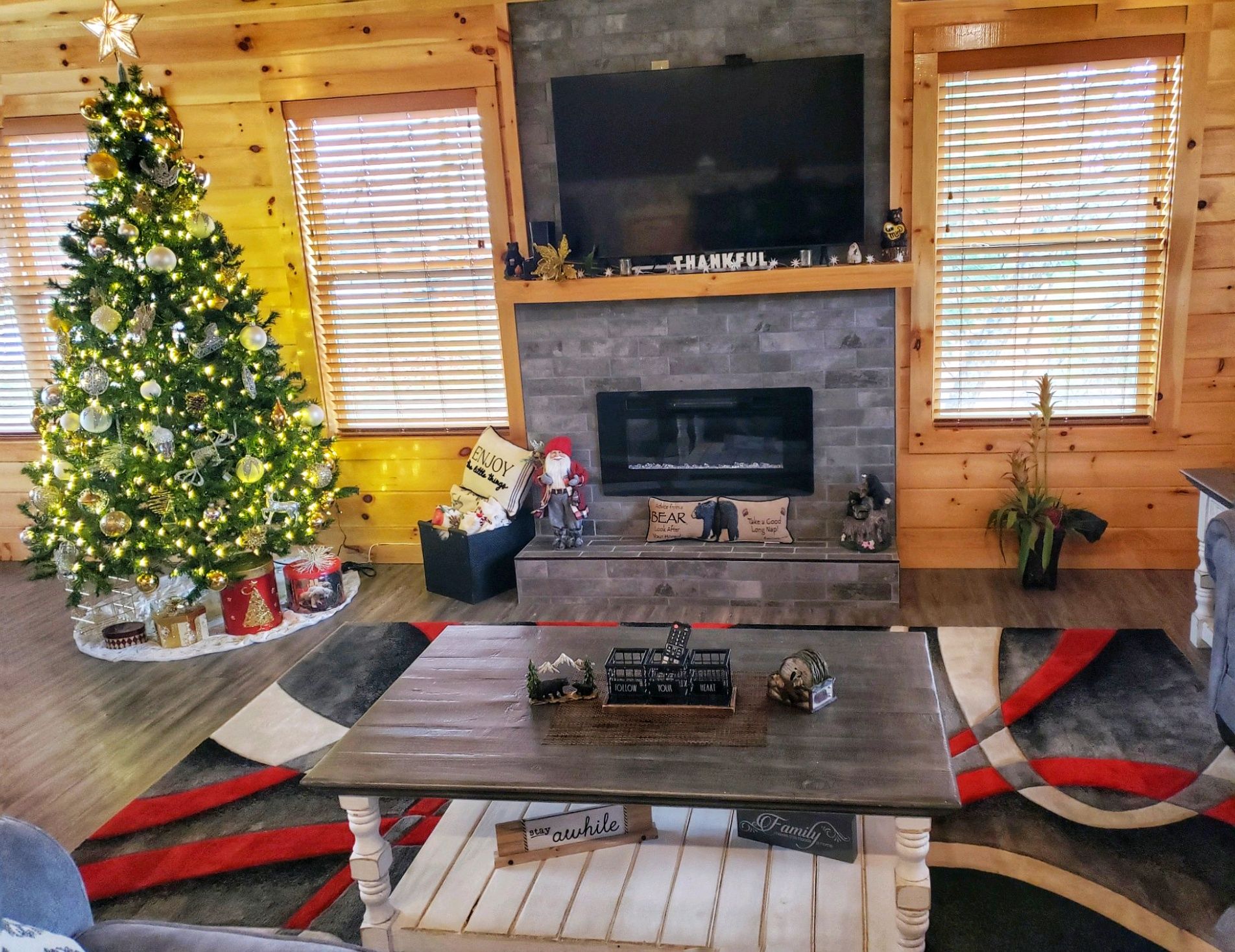 image  Inviting living area with a cozy fireplace, glowing with natural light and holiday charm.