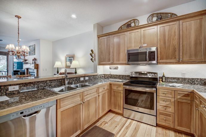 image Gourmet kitchen equipped with modern appliances and elegant granite countertops, perfect for culinary adventures.