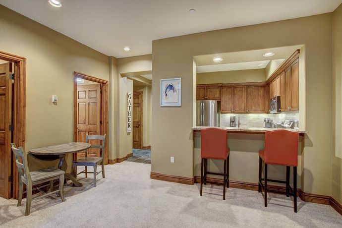 image Bright and inviting entryway showcasing a small dining nook, complemented by warm, earthy tones.