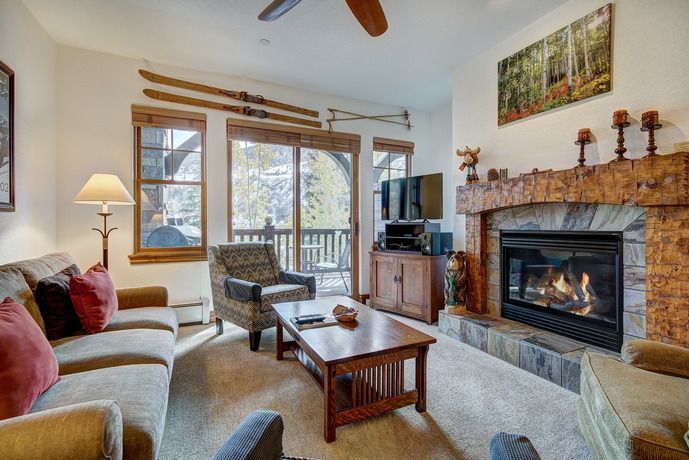 image Cozy living area featuring a fireplace, comfortable seating, and scenic views of the outdoors.