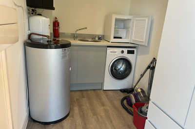 The utility room is accessible by leave the lodge and entering through an outside door.