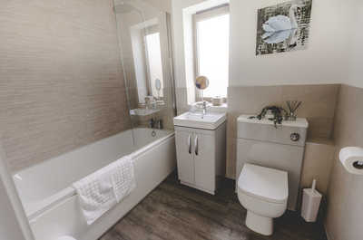 The bathroom features a shower/tub combo.