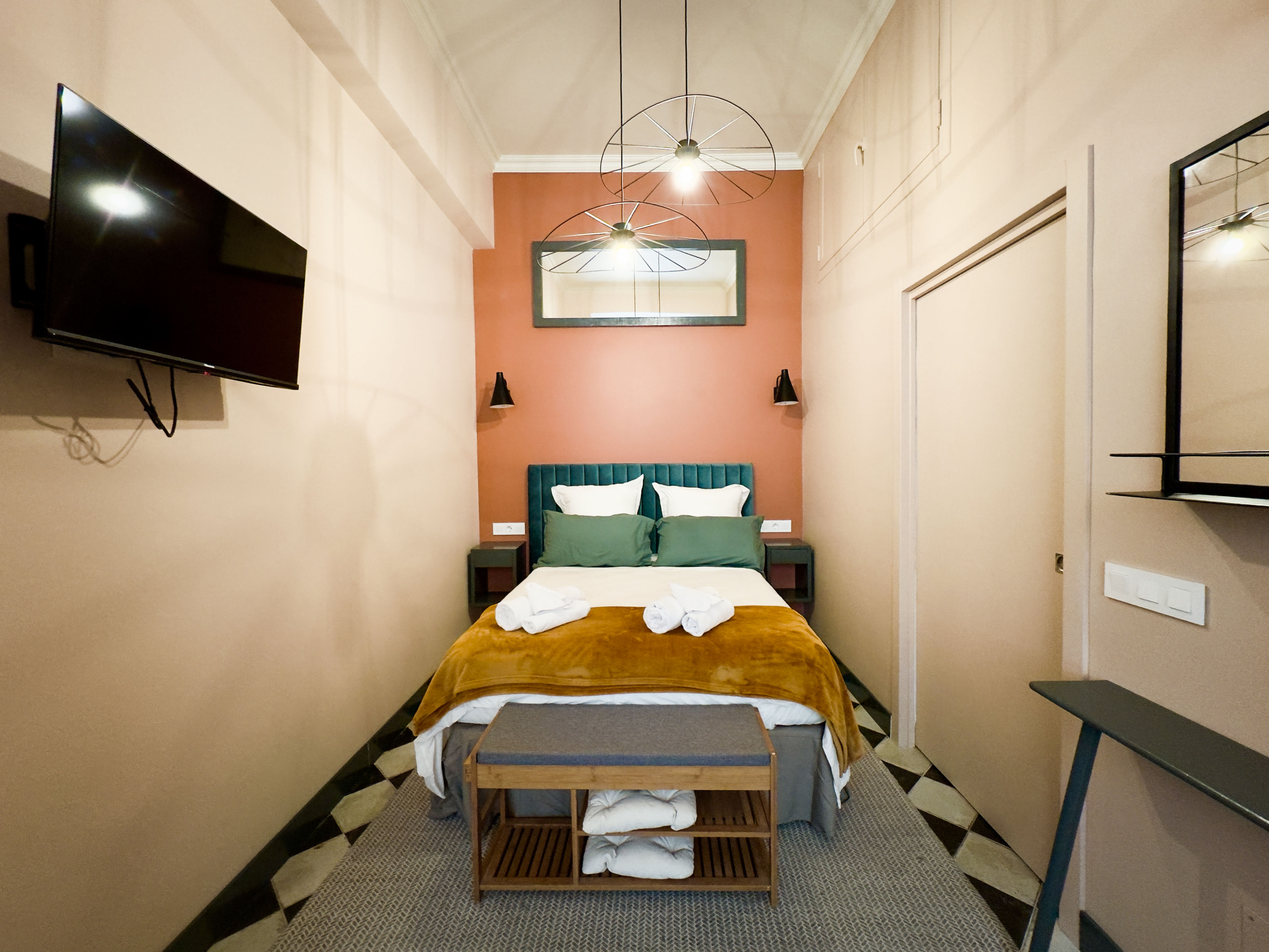 image Comfortable bedroom with a plush double bed and a pop of color, ideal for a restful night after a day at the beach.