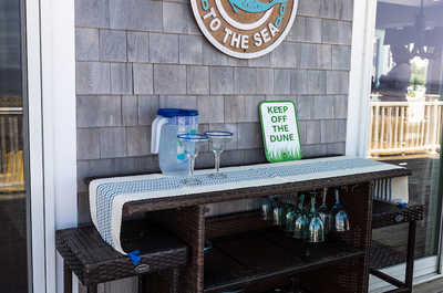 Prepare a refreshing drink by the bar area.