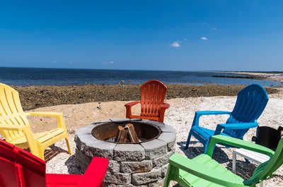 The fire pit area features cozy seating.