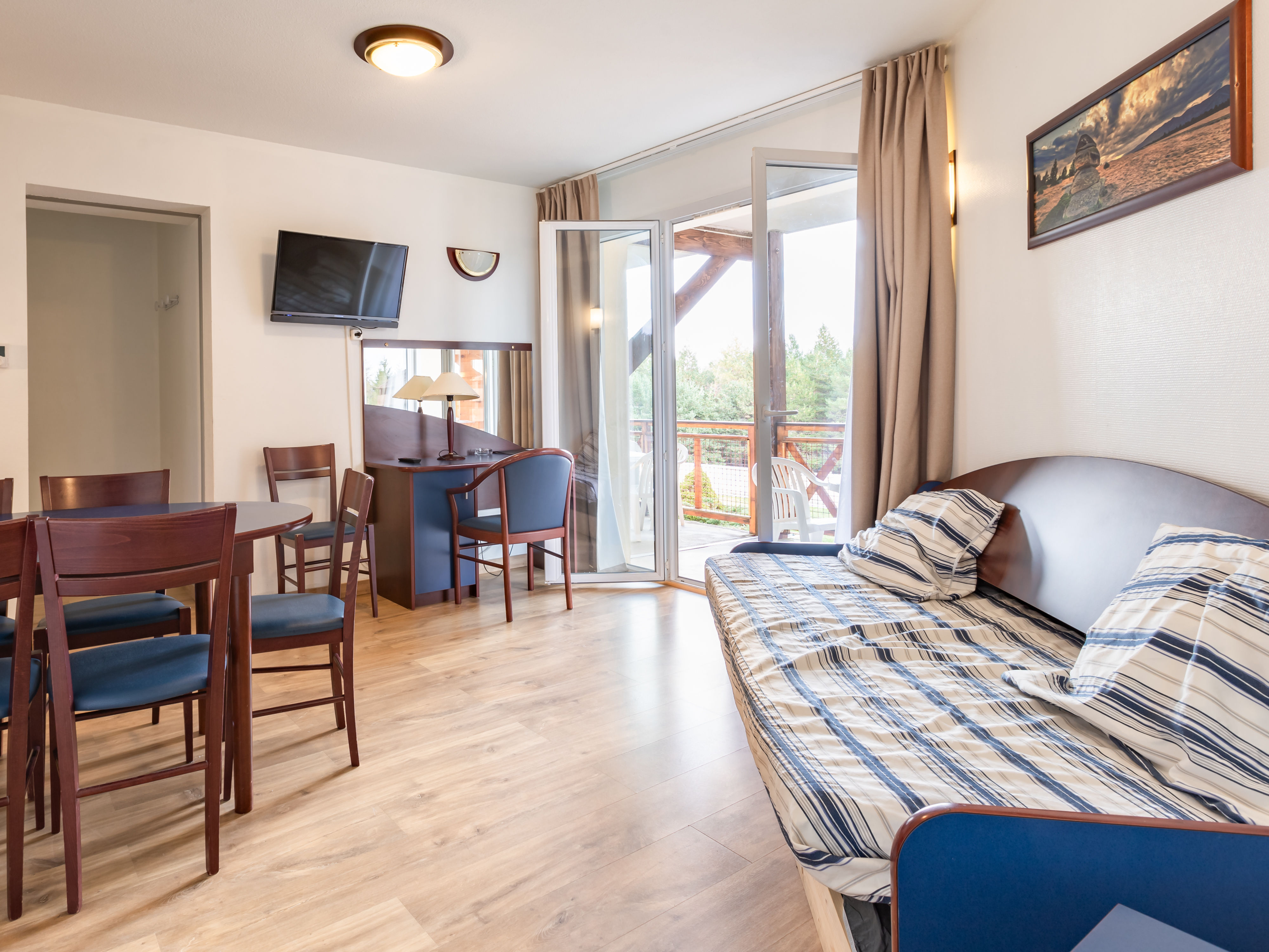 image From the living area, sliding doors open onto the balcony and its mountain view.