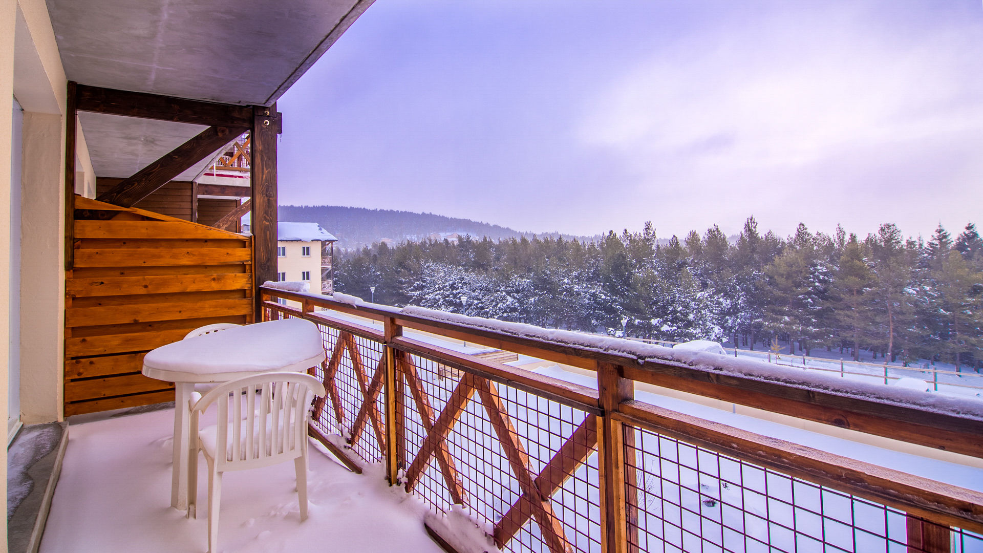image Winter snow blankets the balcony and the trees beyond, a short way from the pistes.