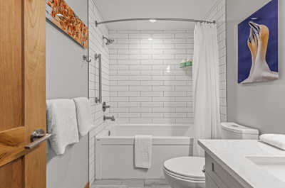 Unwind in the comfortable bathroom, featuring a versatile tub/shower combo.