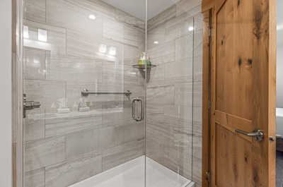 Enjoy a rejuvenating shower experience in the spacious and elegant walk-in shower .