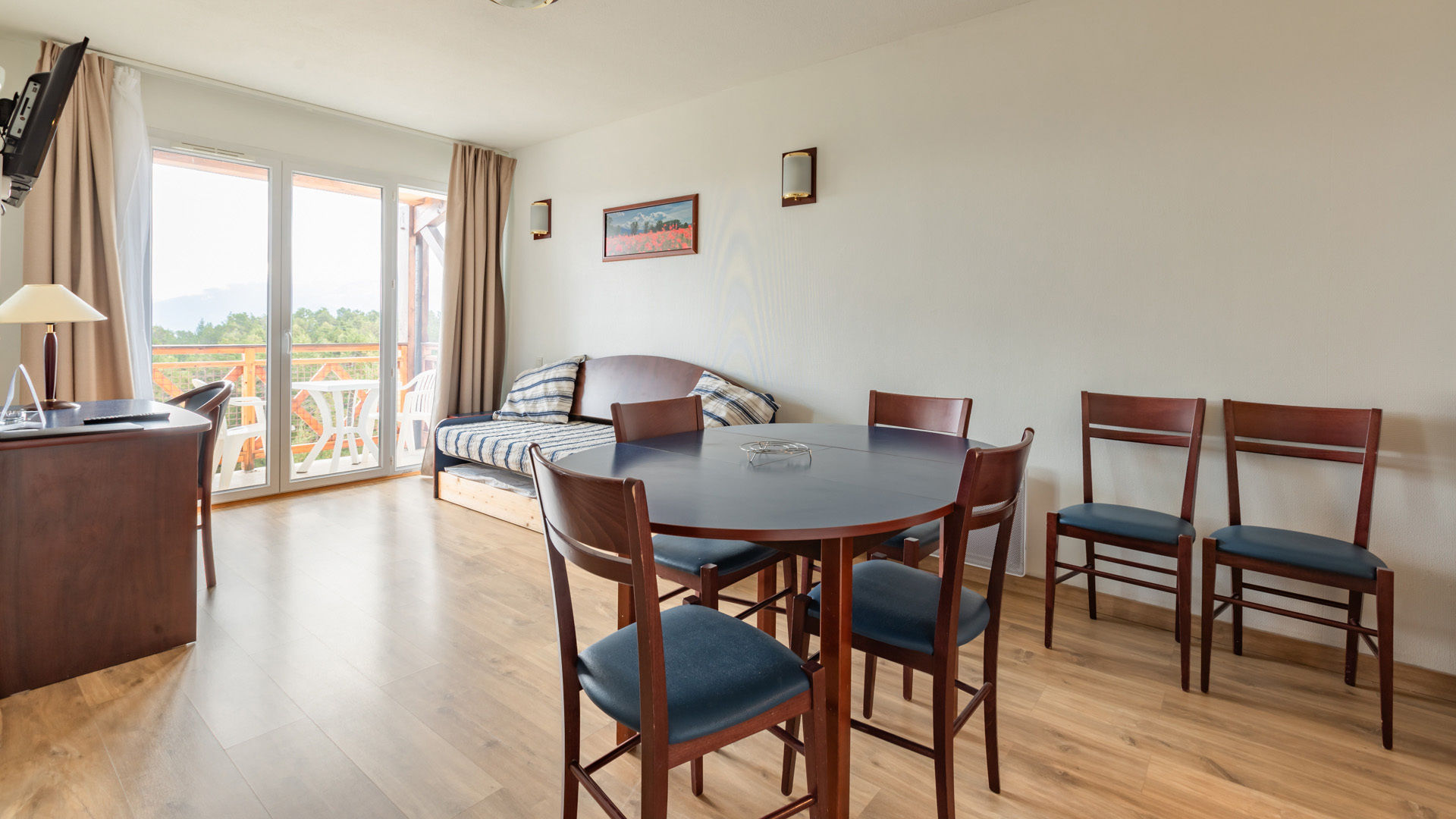 image A bright and airy space with a dining table and comfortable seating, perfect for enjoying meals or unwinding after a busy day.