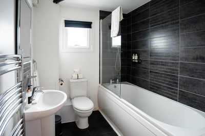 large spacious bathroom with tub / shower combo