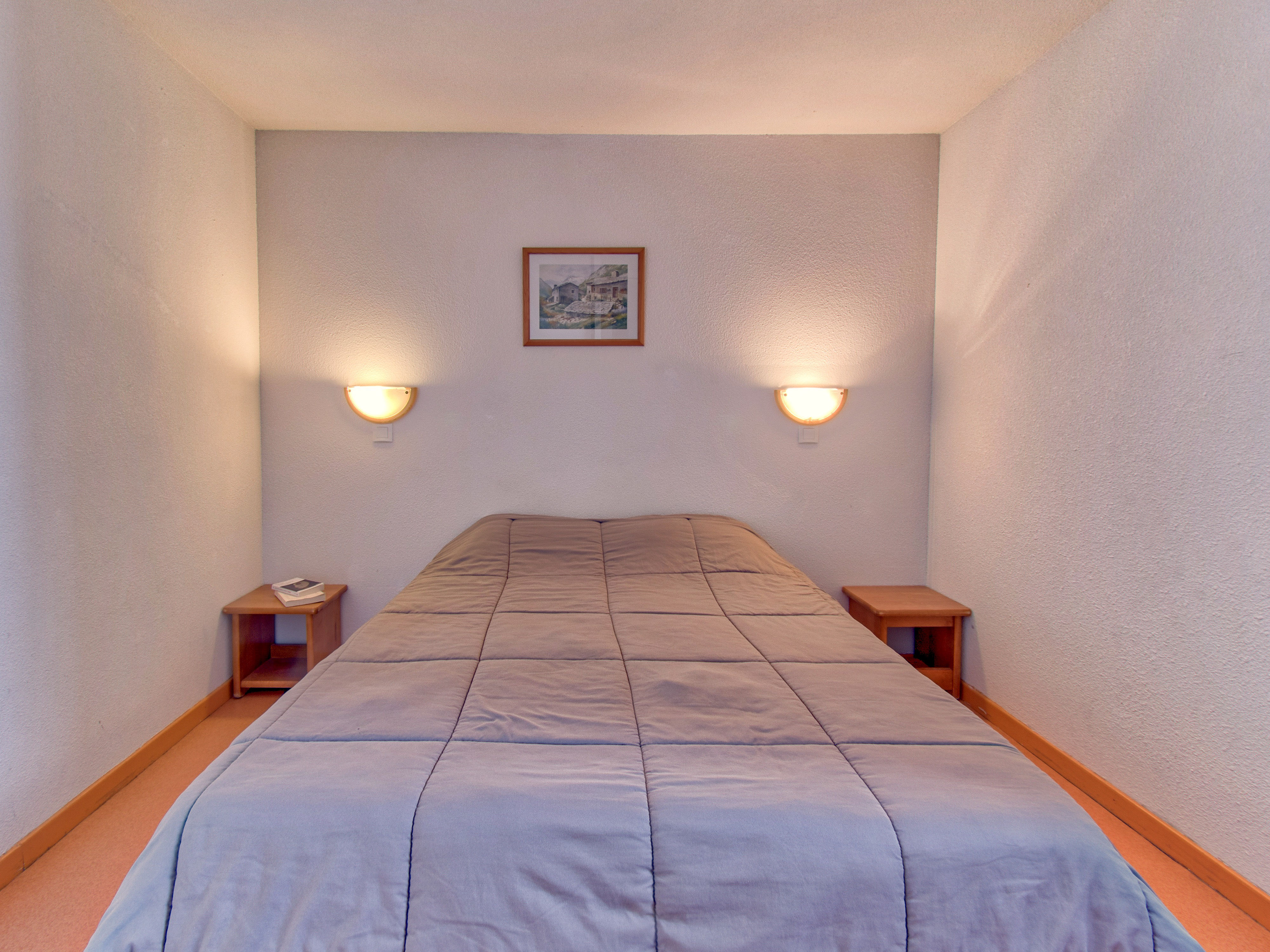 image Cozy single retreat with soft lighting for a peaceful night's rest.