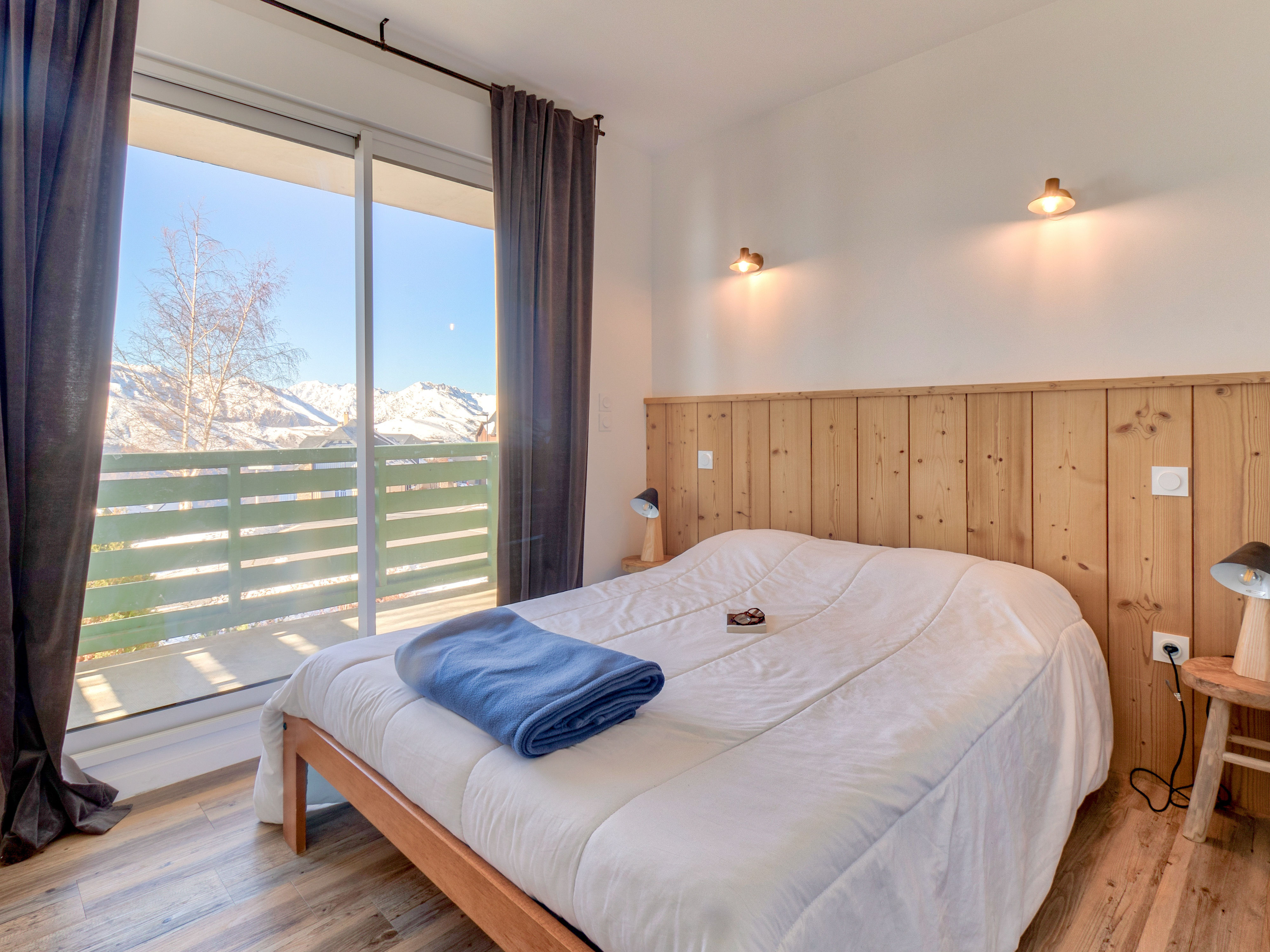 image Alpine dreams await in this rustic-chic bedroom with stunning mountain views.