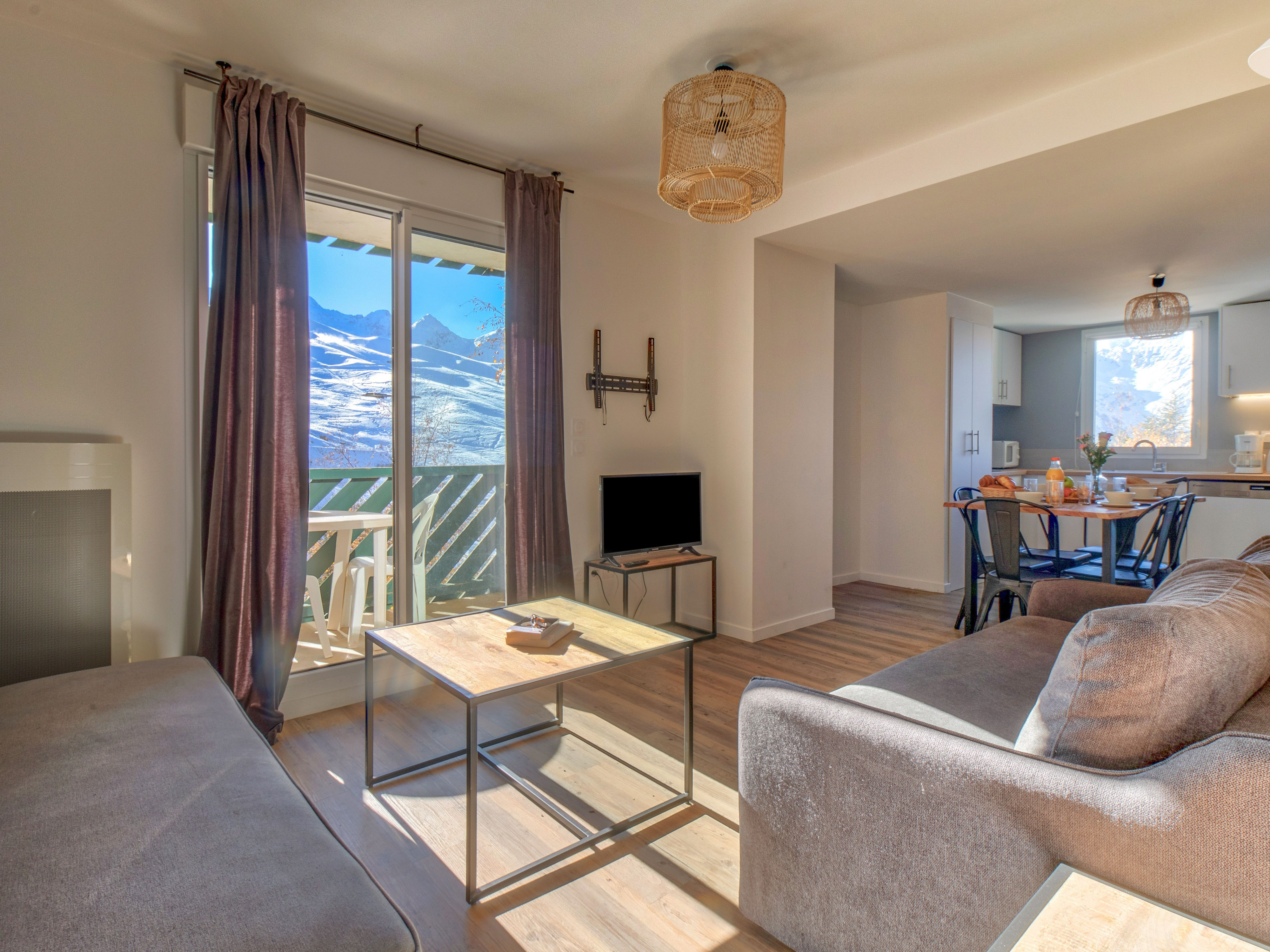 image Contemporary living room with plush seating and picturesque mountain backdrop.