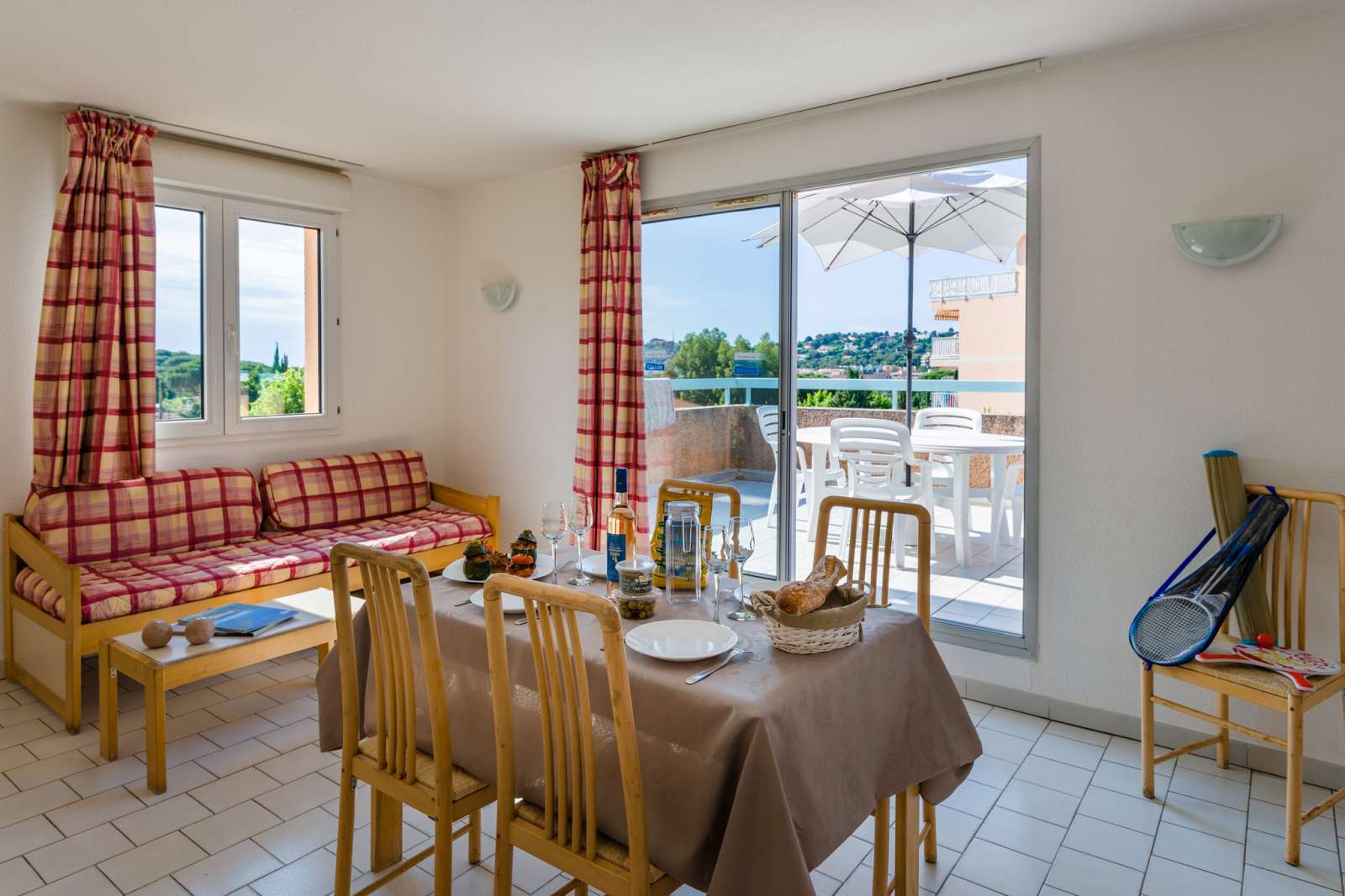 image Comfort meets style in this dining space, featuring a cozy seating area and direct balcony access, making it perfect for meals with a scenic backdrop.