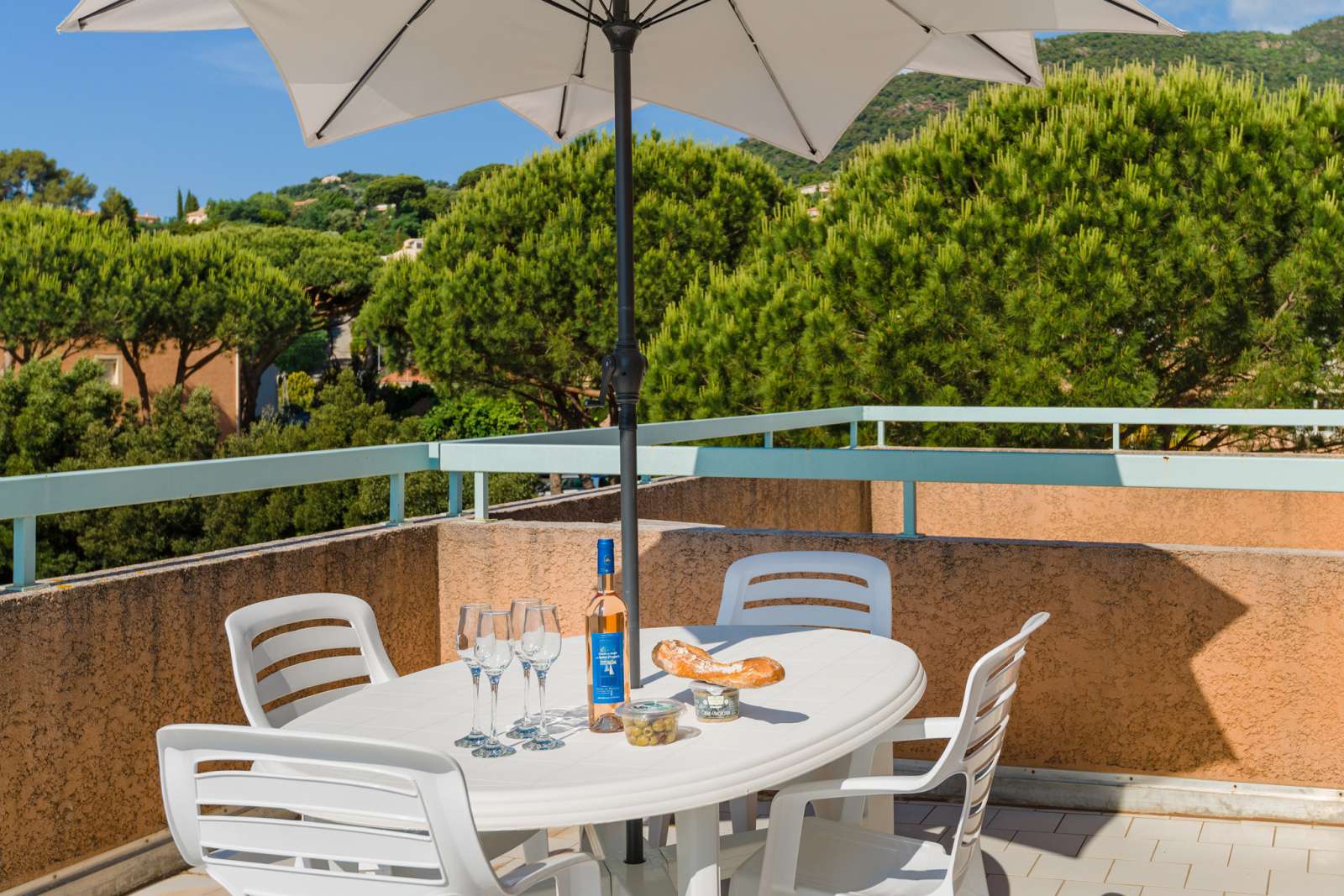 image This sunny balcony invites you to unwind with a glass of wine or a morning coffee, offering a peaceful retreat with nature as your backdrop.