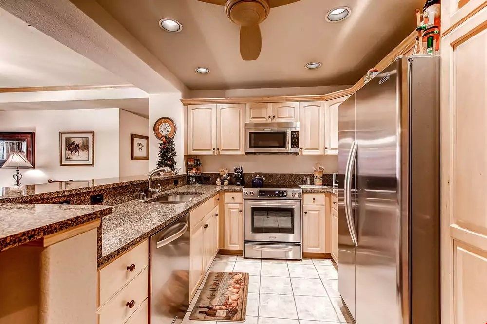 image Prepare your meals in the fully-equipped kitchen featuring modern stainless steel appliances and granite countertops