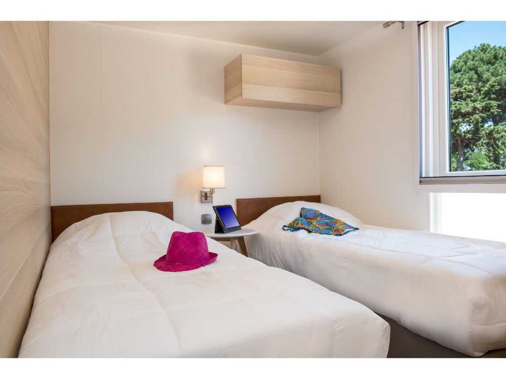 image Comfortable twin bedroom with simple, elegant decor, providing a peaceful space to relax.