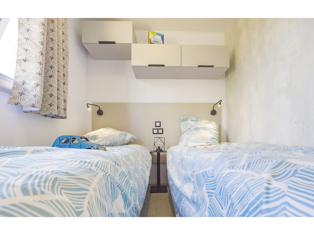 image Cozy twin beds in a bright room, offering a comfortable space to recharge after a day of adventure.