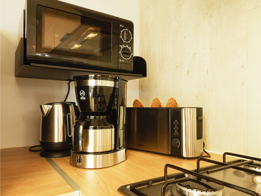 image A compact kitchen setup with everything you need to enjoy morning coffee or a quick meal.
