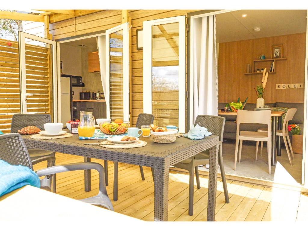 image A welcoming dining setup on the deck, perfect for alfresco meals with friends and family.