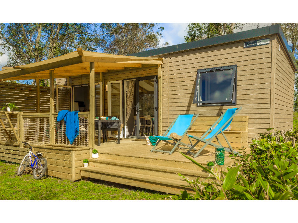 image Enjoy outdoor living on this charming deck, complete with cozy lounge chairs for ultimate relaxation.