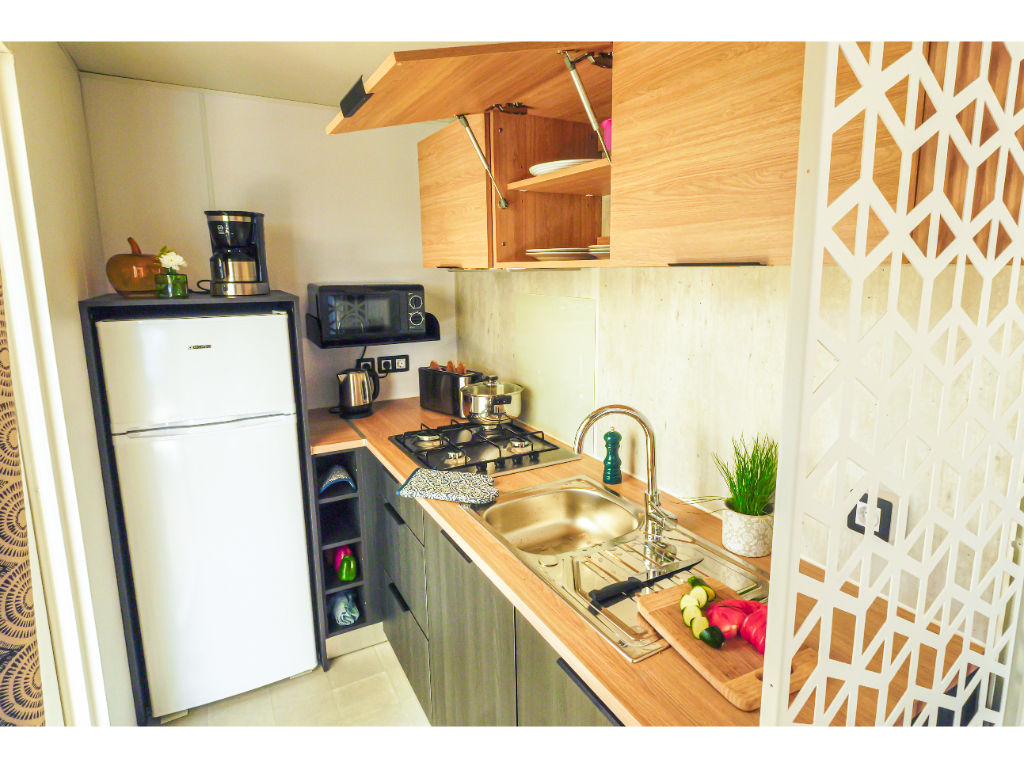 image Compact and stylish kitchen with everything you need to whip up a delicious meal.