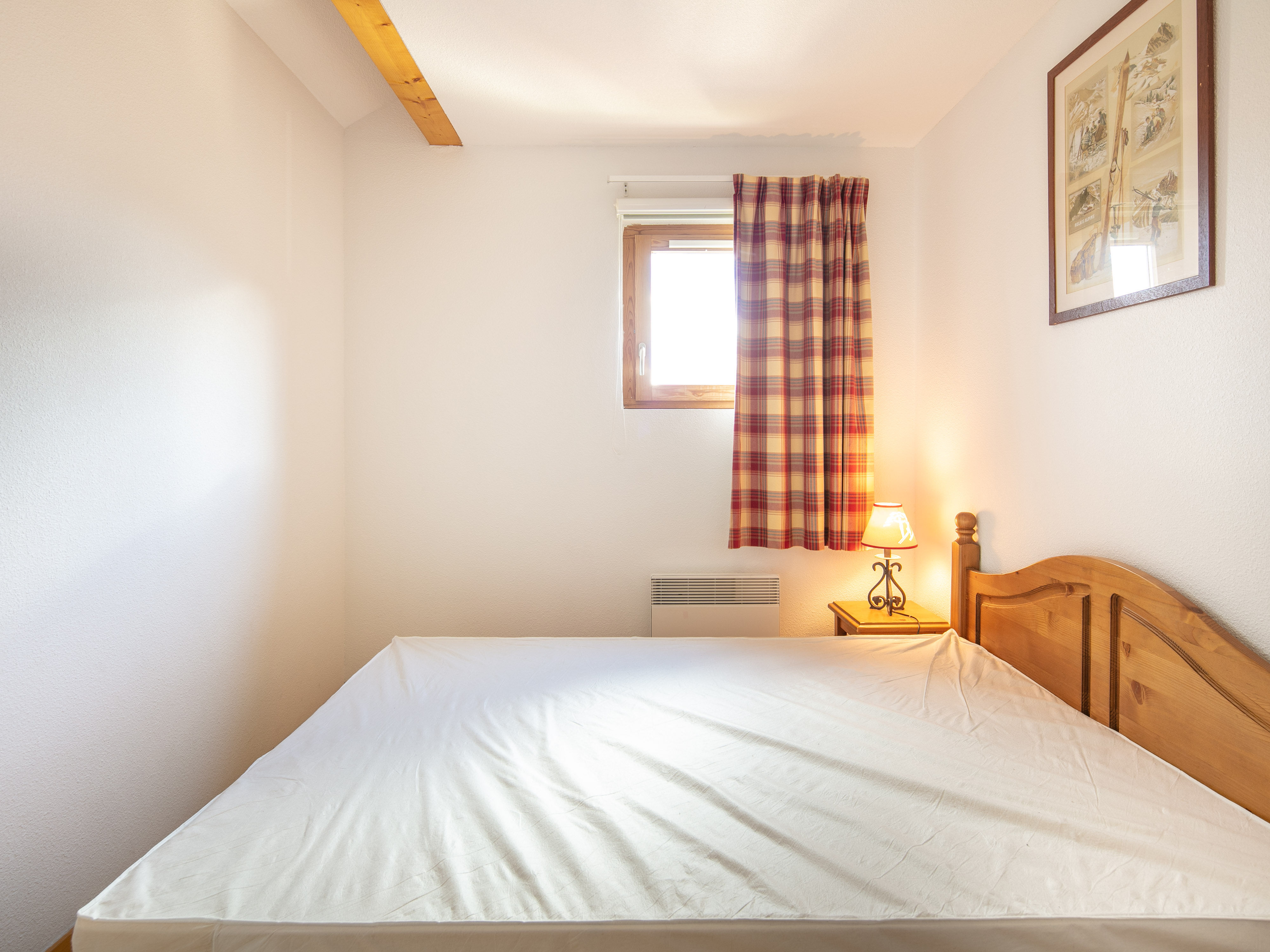 image The bedside lamp and wall art give the bedroom a restful end to a day on the pistes.