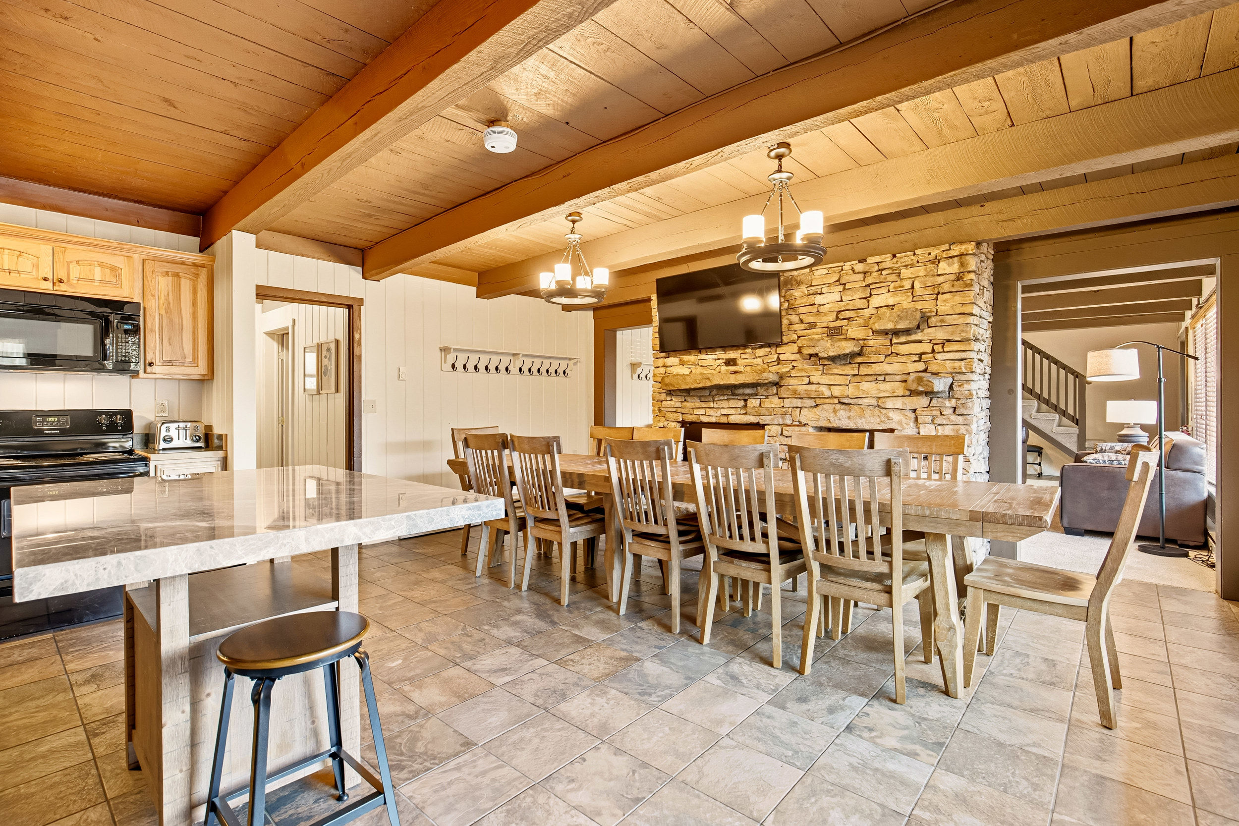 image The open kitchen and dining area accommodates up to 18 guests, providing a warm and inviting space for family meals and celebrations.