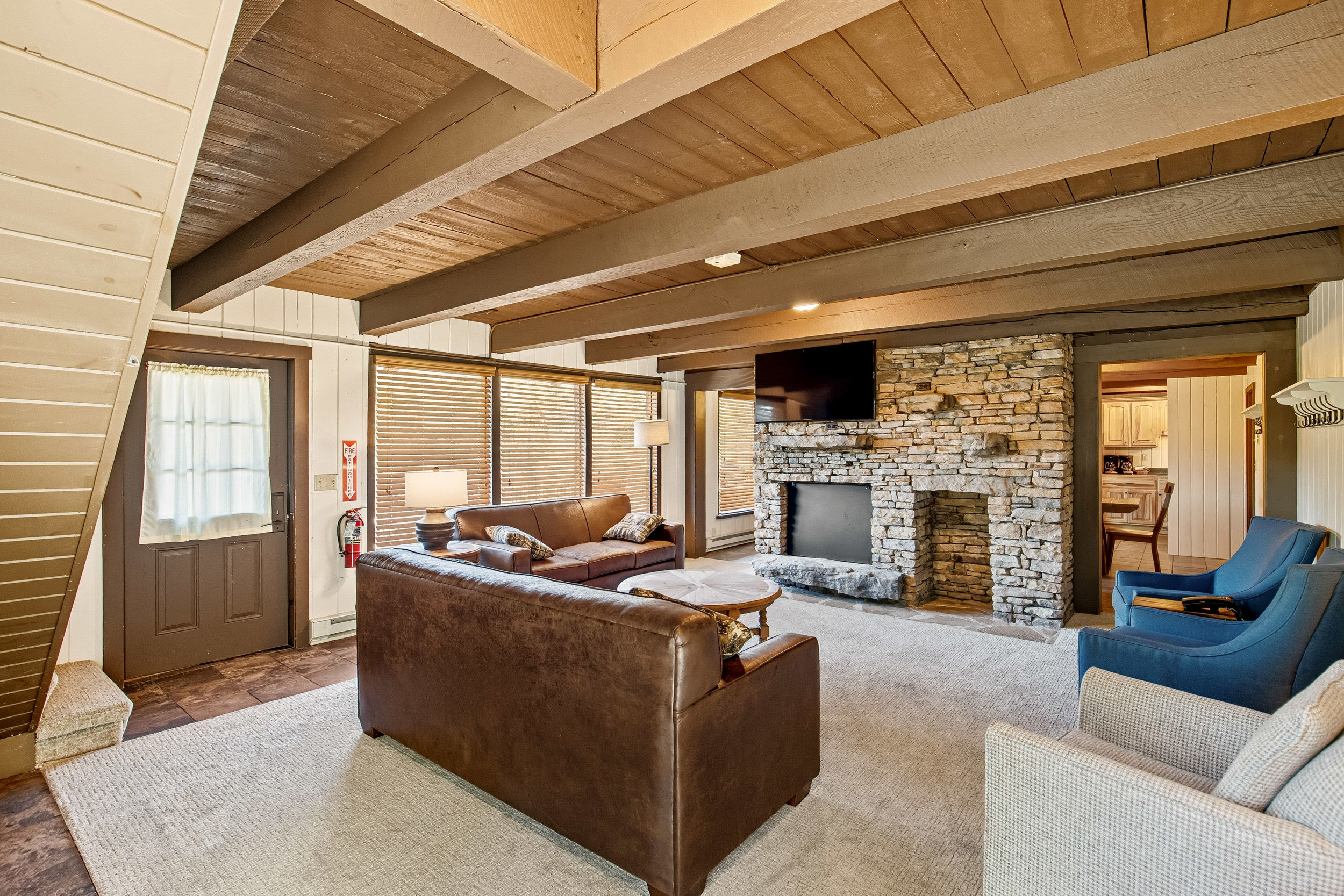image The cozy living area features a stone fireplace and comfortable seating, perfect for relaxing after a day of mountain adventures.