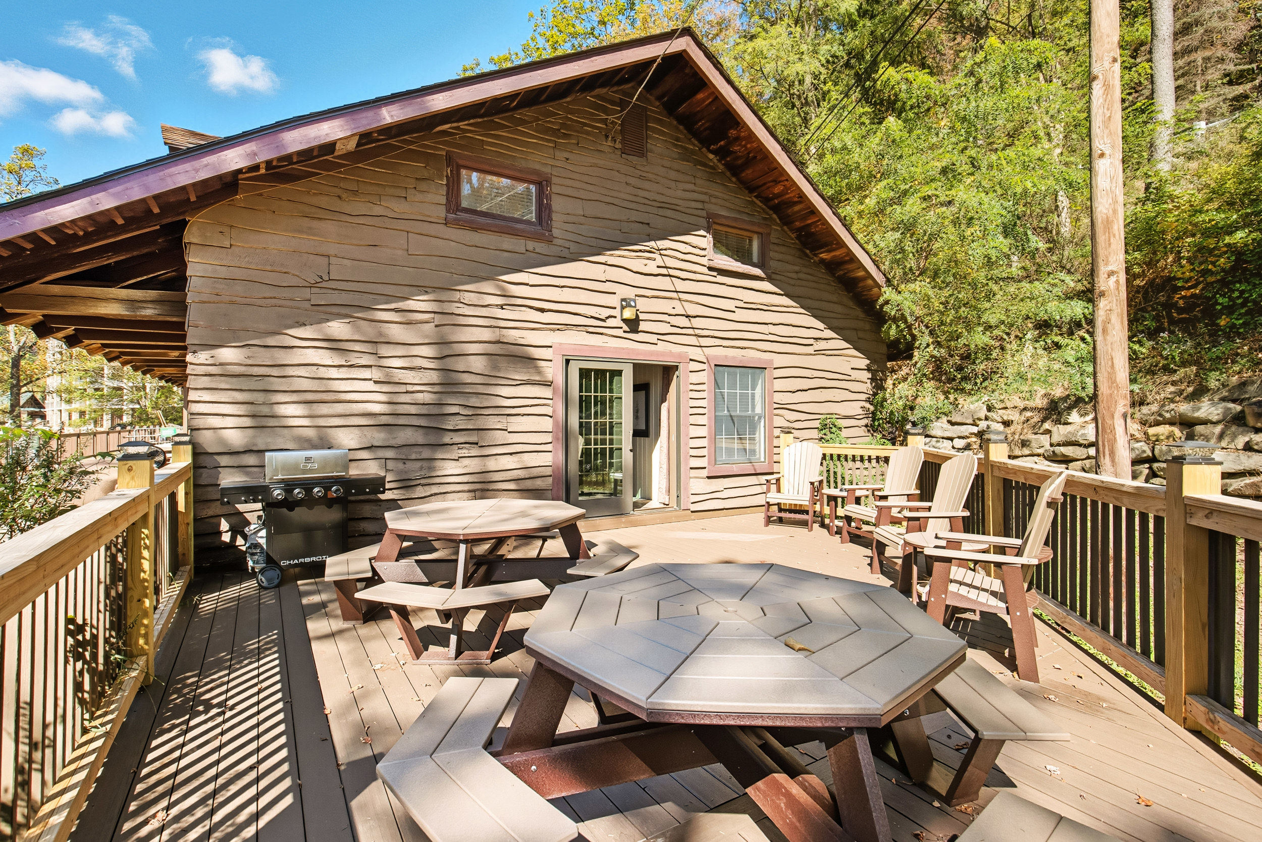 image The expansive deck is ideal for gatherings, complete with ample seating and a barbecue grill for outdoor cooking.