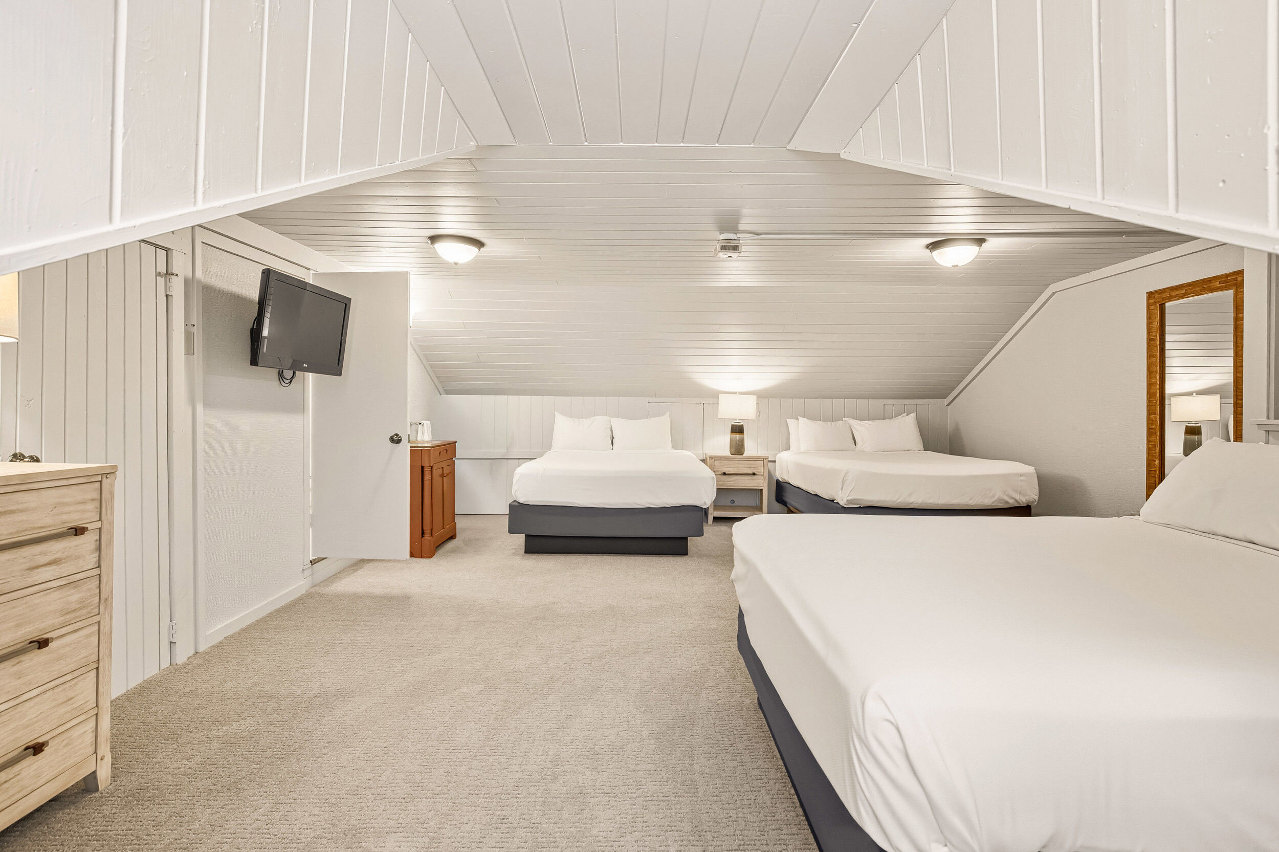 image The spacious loft bedroom features multiple beds, ideal for families, while offering a bright and airy atmosphere with charming rustic details.