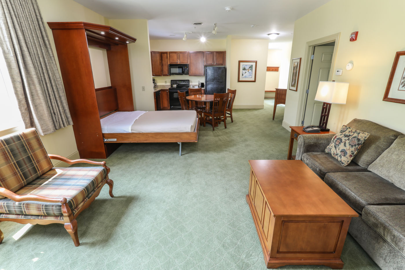 image Open-concept layout with a convenient Murphy bed, offering flexibility and extra space when needed.
