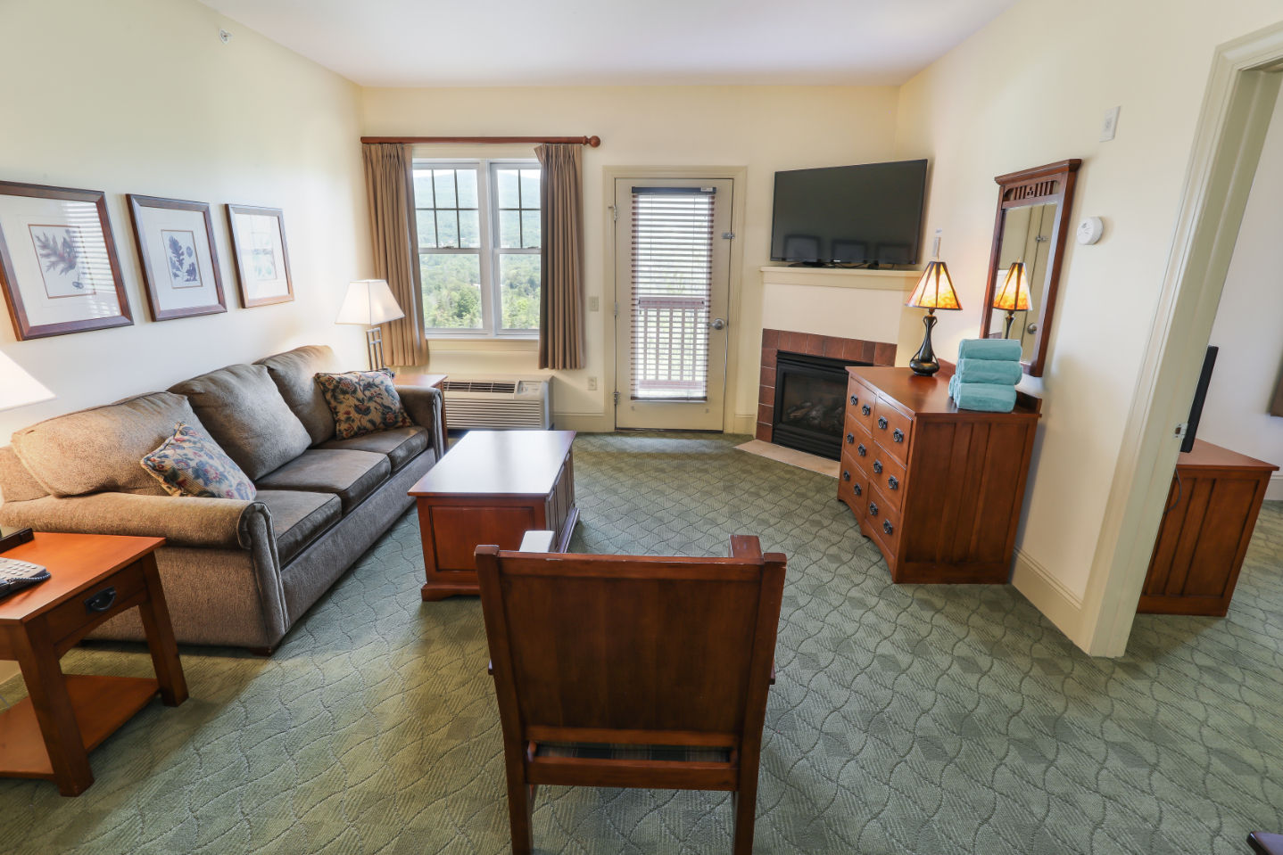 image Charming living space featuring a fireplace and plush seating, offering a cozy and welcoming ambiance.