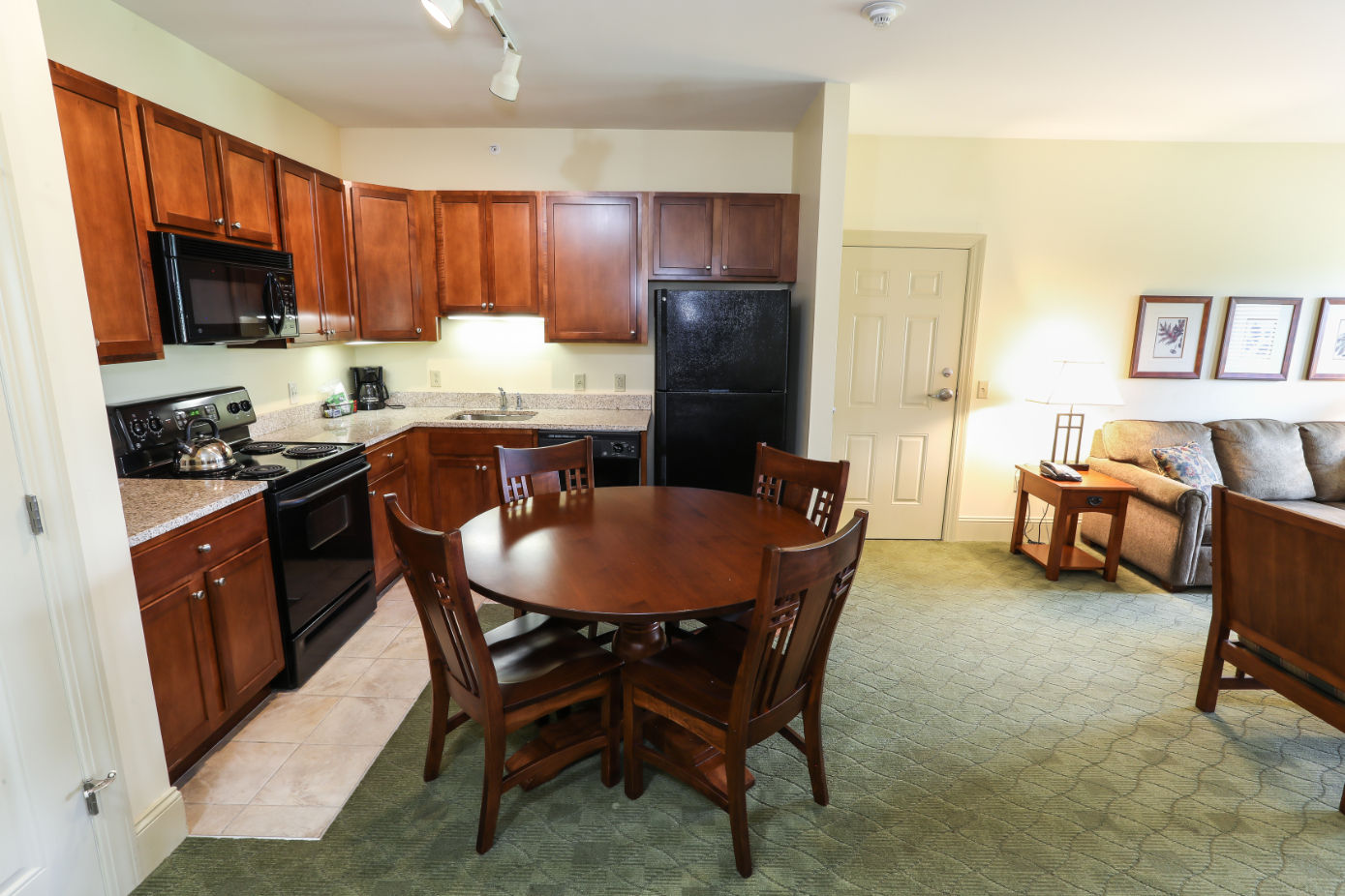 image Equipped kitchen and dining area, perfect for preparing and enjoying meals during your stay.