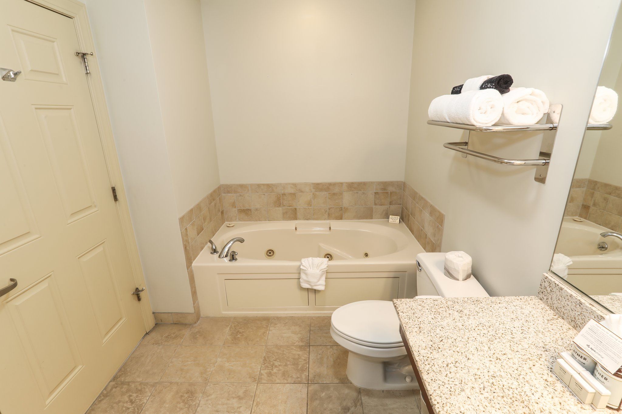 image Spacious bathroom with a bathtub and modern fixtures for added comfort.