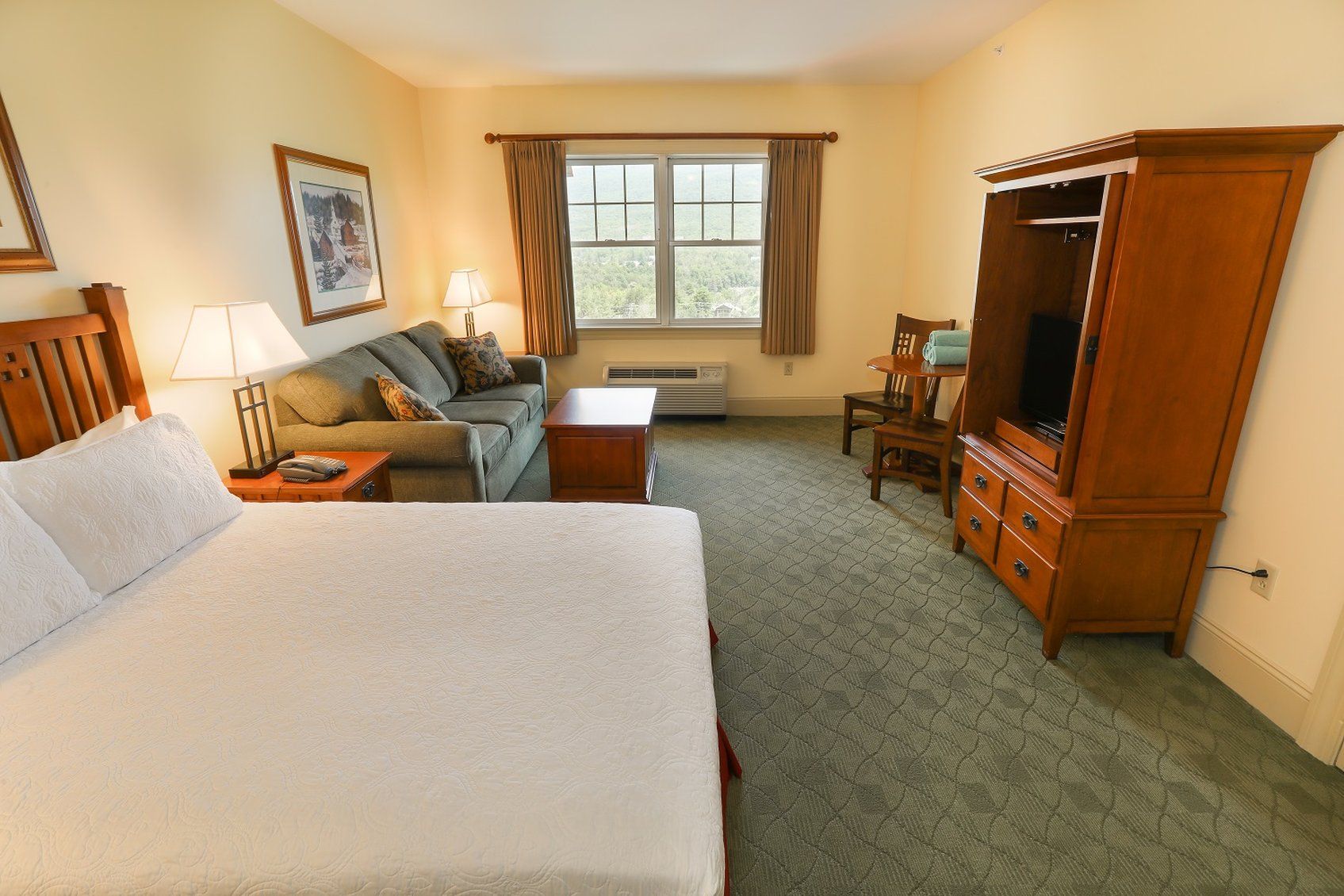 image Spacious guest room with a plush bed and cozy seating area, perfect for unwinding after a busy day.